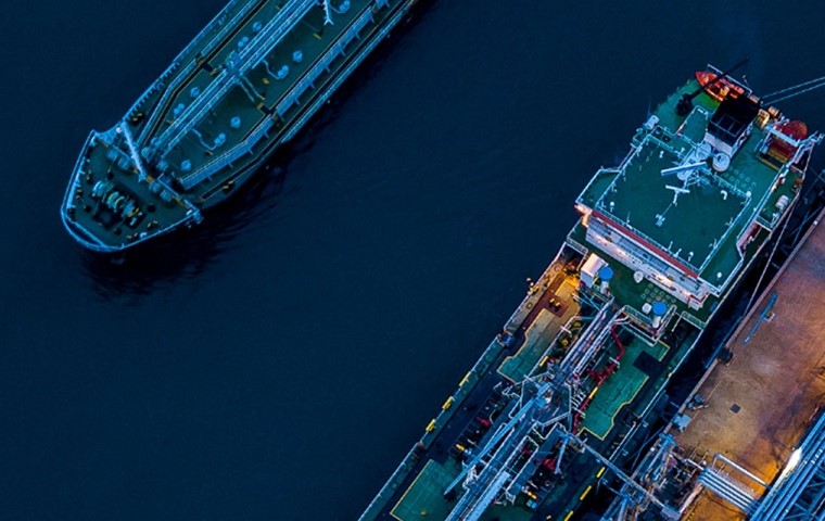 Petroleum fuel shipping vessel on the sea adjacent to a Shipping dock